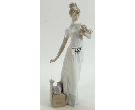 Lladro figure of a lady holding a puppy with a suitcase and umbrella: Lladro figure of a lady holding a puppy with a suitcase