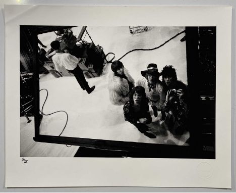 A silver gelatin print (16x20") of an image by Michael Cooper, depicting The Rolling Stones with producer Glyn Johns. #3/25. 