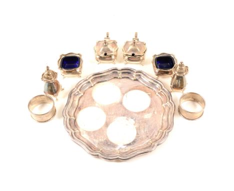 A set of six silver condiments by William Hutton &amp; Sons Ltd, comprising four pots with blue glass inserts, two with lids 