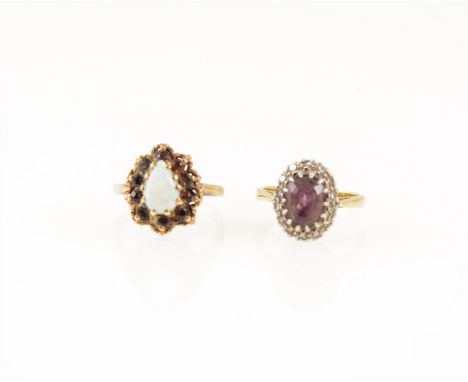 Two gemset dress rings, an oval mixed cut amethyst surrounded by fourteen eight cut diamonds in a yellow and white metal moun