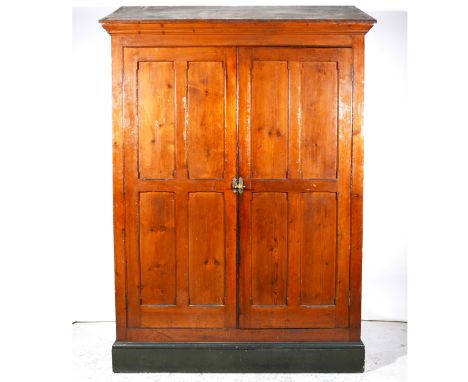 A pitch pine Gothic Revival style wardrobe/ cloak cupboard, by repute previously from Lichfield Fire Station, sloping top wit