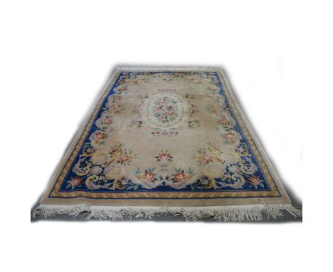 Chinese sculptured wool carpet, floral medallion on a fawn field, foliate outlines, 320 x 206cm.