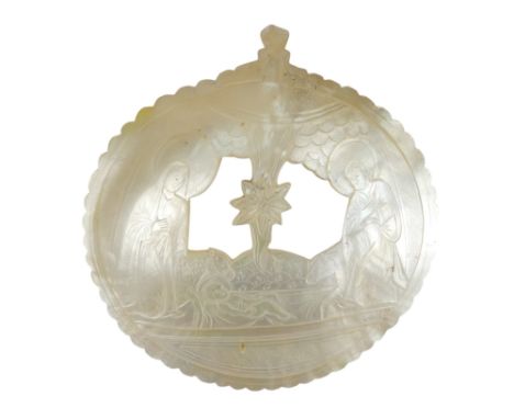 A Jerusalem carved mother-of-pearl icon shell  - pierced and decorated with The Nativity Scene, 15cm high.