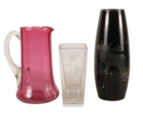 A 20th century clear glass vase - of square tapering form and etched with a flower, 15cm high, together with a ruby glass jug