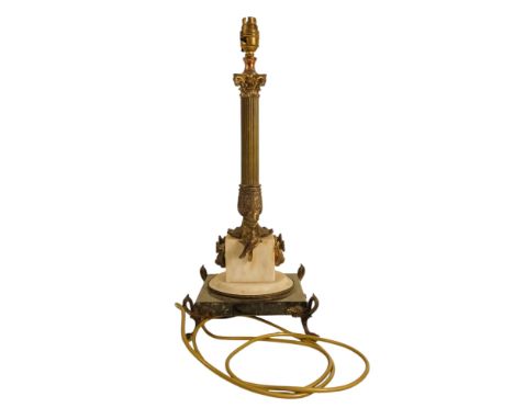 A brass and marble table lamp - modelled as a Corinthian column, the square white marble base with putto and raised on claw p
