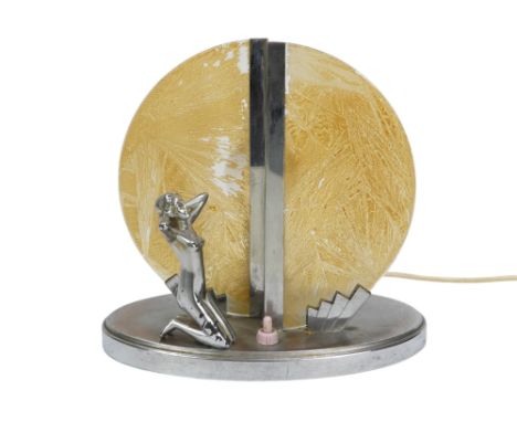 An Art Deco chrome and glass table lamp - modelled with a kneeling figure before a yellow disc, 22cm high.