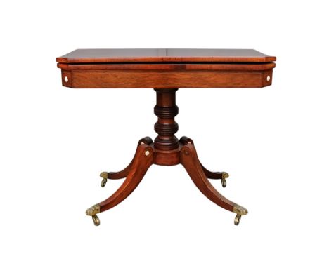 A George IV rosewood card table - the rectangular top with canted corners, on a turned support and platform base, with sabre 