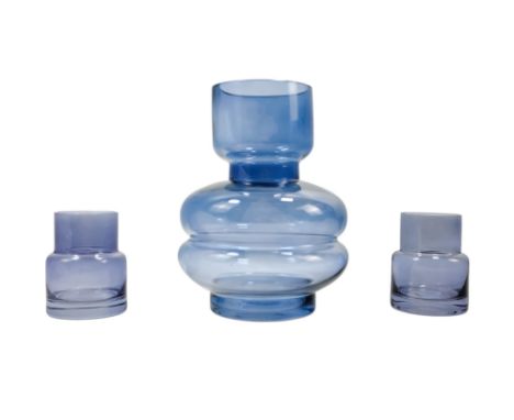 A blue glass carafe - height 20cm, together with two matching glasses.