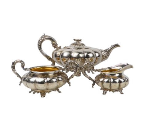 A William IV three piece tea service - Dublin 1833, James Moore, of squat gourd form and engraved with foliage and incorporat