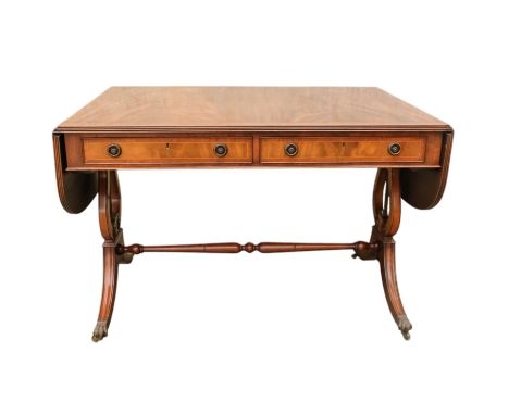 A George III sytle mahogany sofa table - the rectangular top with drop ends, on lyre shaped end supports joined by a turned s