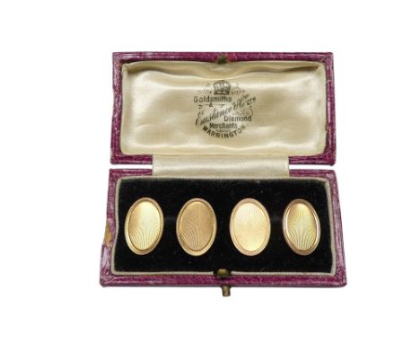 A pair of 9ct gold cufflinks - with engine turned oval buttons linked by chains, 6g.