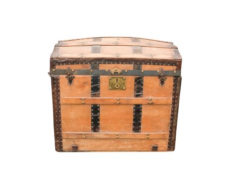 An early 20th century beech and iron bound trunk - with a domed lid and laths, including iron fittings and bail handles and a