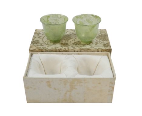 A pair of Chinese spinach jade cups - of tulip form and raised on a foot rim, 3cm high, within a presentation box.