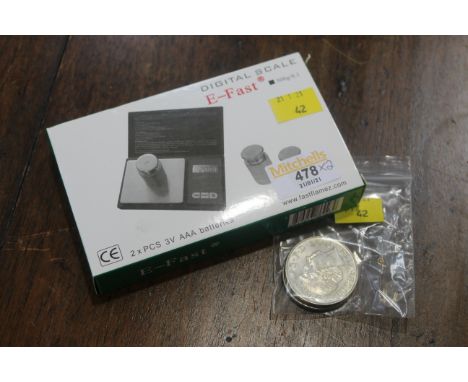 Set of digital scales and two £5 coins