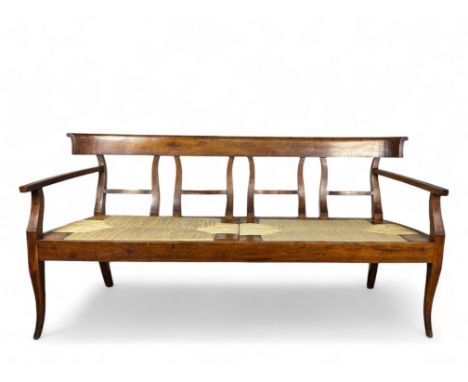 A 19th century North Italian fruitwood rushed seated bench or settee The rectangular top-rail above a pierced splat, open arm