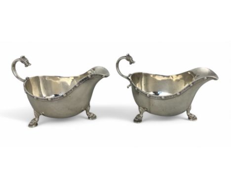 A pair of Elizabeth II silver sauceboats, Adie Brothers Ltd., Birmingham 1960 With grotesque mask scroll handles, Celtic desi