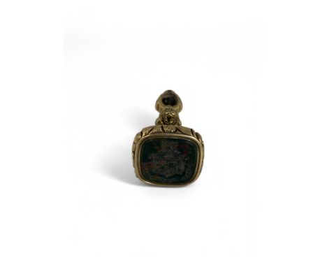 A 19th century gilded fob seal The fluted head with foliate scroll rim, bloodstone seal for the Petre family, with coat-of-ar