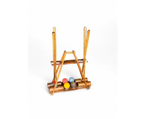 An early 20th century&nbsp;'The Usborne' croquet stand by F H Ayres, London, four mallets and&nbsp;Jaques Eclipse balls&nbsp;