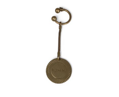 A 9ct gold torc shape keyring (London hallmarks 1961) Chain and 9ct disc pendant with initials, also marked ‘9.375’, disc 32m