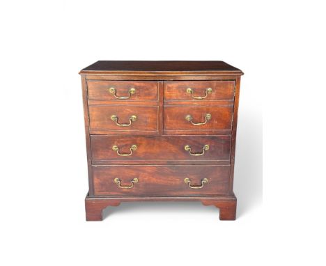 A George III mahogany bedside commode The rectangular hinged top above a pair of cupboard doors (one detached), a drawers and