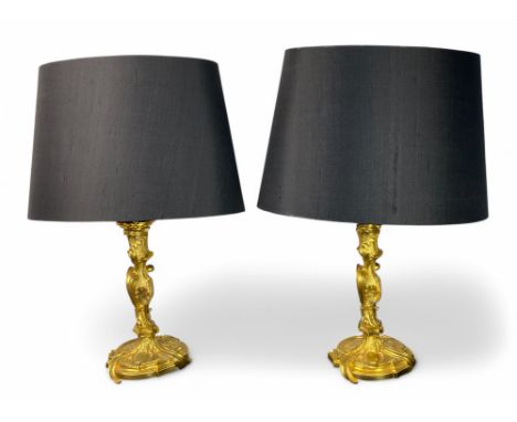 A pair of 19th French Louis XV style gilt bronze candlesticks with detachable lamp fittings The shaped sconces above 'C' scro
