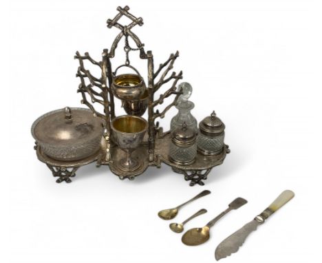 An early 20th century silver plated novelty rustic style breakfast set With central chained cauldron flanking toast rack bran
