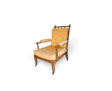 An early Victorian beech bobbin turned armchair The pierced back with turned uprights and top rail and a squab cushion, the p