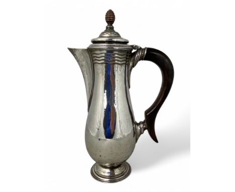 A George V silver hot water jug, Henry George Murphy, London 1936 Of slender baluster form with turned hinged ripple decorate