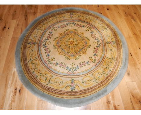 Circular cream ground carpet, of floral design within grey borders, 178cm diam