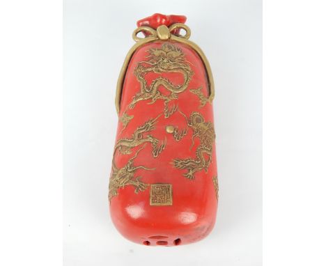 Chinese ceramic pillow in the form of a sack of rice, gilt painted bow and dragon decoration, applied character stamp, 32cm