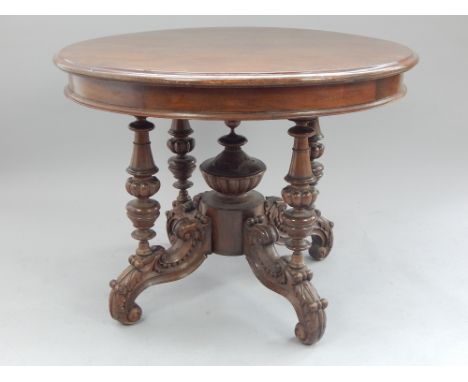 Anglo-Chinese centre table, 19th C, mahogany, central finial carved cup and cover supports, set on four scroll carved legs wi