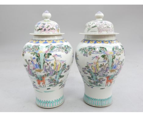 Pair of Chinese baluster shaped lidded vases, decorated with figures playing a board game in a garden, 40cm h (2)