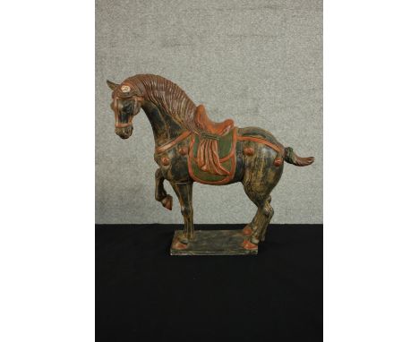 A Chinese Tang style painted ceramic horse on rectangular base. (Broken ear.) H.39 W.43 D.14cm. 
