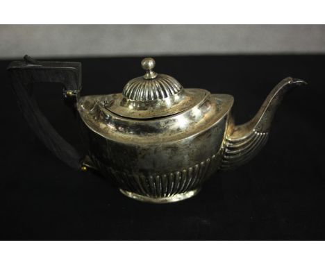 An Austrian gadrooned silver tea pot with ebony handle. Hallmarked: Austrian assay marks, maker's mark JW. H.10 W.21 D.9cm. W