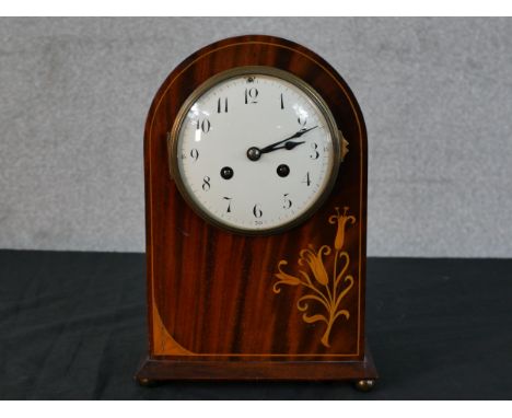 An Edwardian inlaid mahogany dome topped mantle clock, white enamel dial with black painted Arabic numerals and applied hands