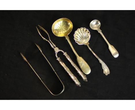 A collection of silver and white silver plate cutlery, including a Russian gilded silver floral engraved sugar sifting spoon,