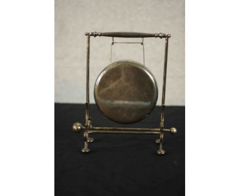 A silver plate table gong on stand with beater. H.19 W.19 D.8cm. 