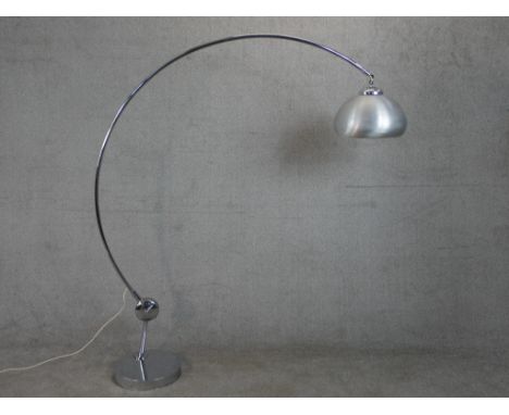A chrome Arc style lamp, with a brushed aluminium shade, a curved tubular body and a circular base. H.178 W.145cm 