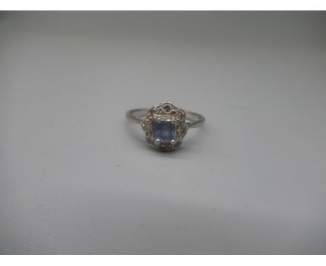 Platinum cluster ring, the central pale blue stone surrounded by diamonds, stamped plat, size P, 3.3g 