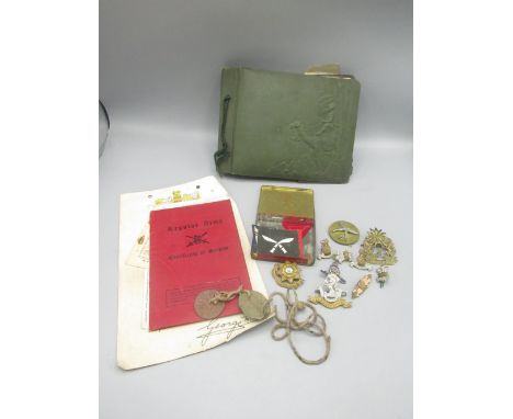 Tin containing various regimental cap badges and shoulder patches, WWII dog tags for 'Armitage 186935', Regular Army Certific