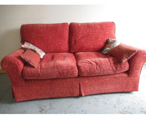 Traditional shape two seat sofa, upholstered in self patterned rust fabric, loose back and seat cushions and four scatter cus