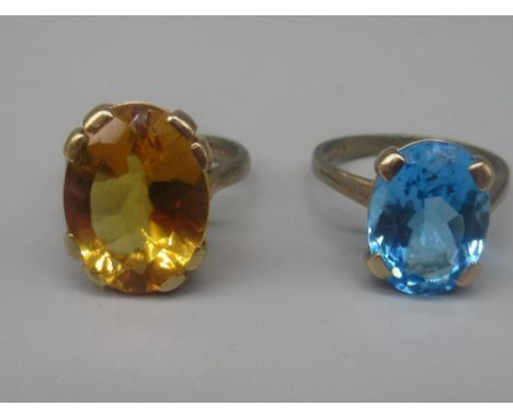 9ct yellow gold ring set with oval cut citrine, size J1/2, and another set with blue topaz, size N, both stamped 375, 8.2g 