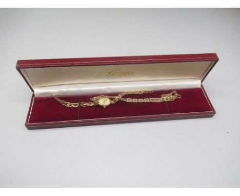 Ladies 9ct yellow gold Geneve wristwatch, on three bar gate chain, clasp stamped 375, and a matching 9ct yellow gold bracelet