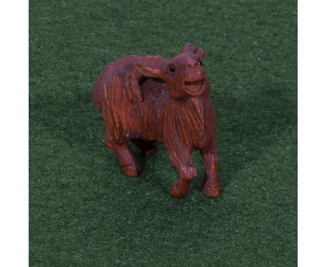 A small hardwood goat netsuke 