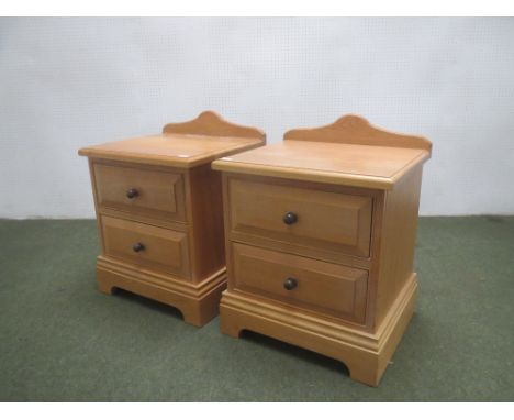 Pair of light oak two drawer bedside chests, 54.5 cm wide PROVENANCE: Part of the clearance of the former premises in Chiseld