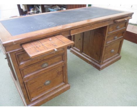 Pitch Pine pedestal desk, the leatherette top over a bank of three drawers to each side and a stained pine swivel captains ch