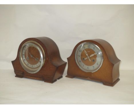 An oak mantle clock by Enfield  "Early c20 Mahogany inlaid bracket clock and bracket with brass dial, Arabic numerals and chi