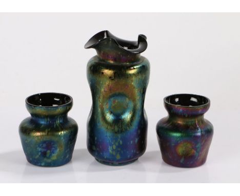 Trio of Art Nouveau iridescent glass vases, possibly Loetz, the larger vase with a folded lip above a dimpled body, 18cm high