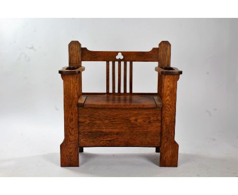 Arts and Crafts oak hall seat, having stick stand divisions either side of a storage seat, with slatted back, 84cm wide