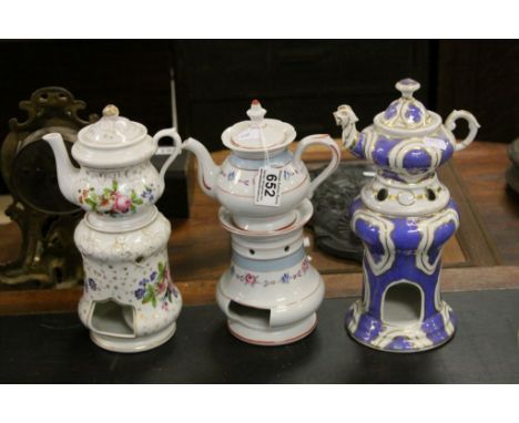 Three ceramic teapots with burner stands 